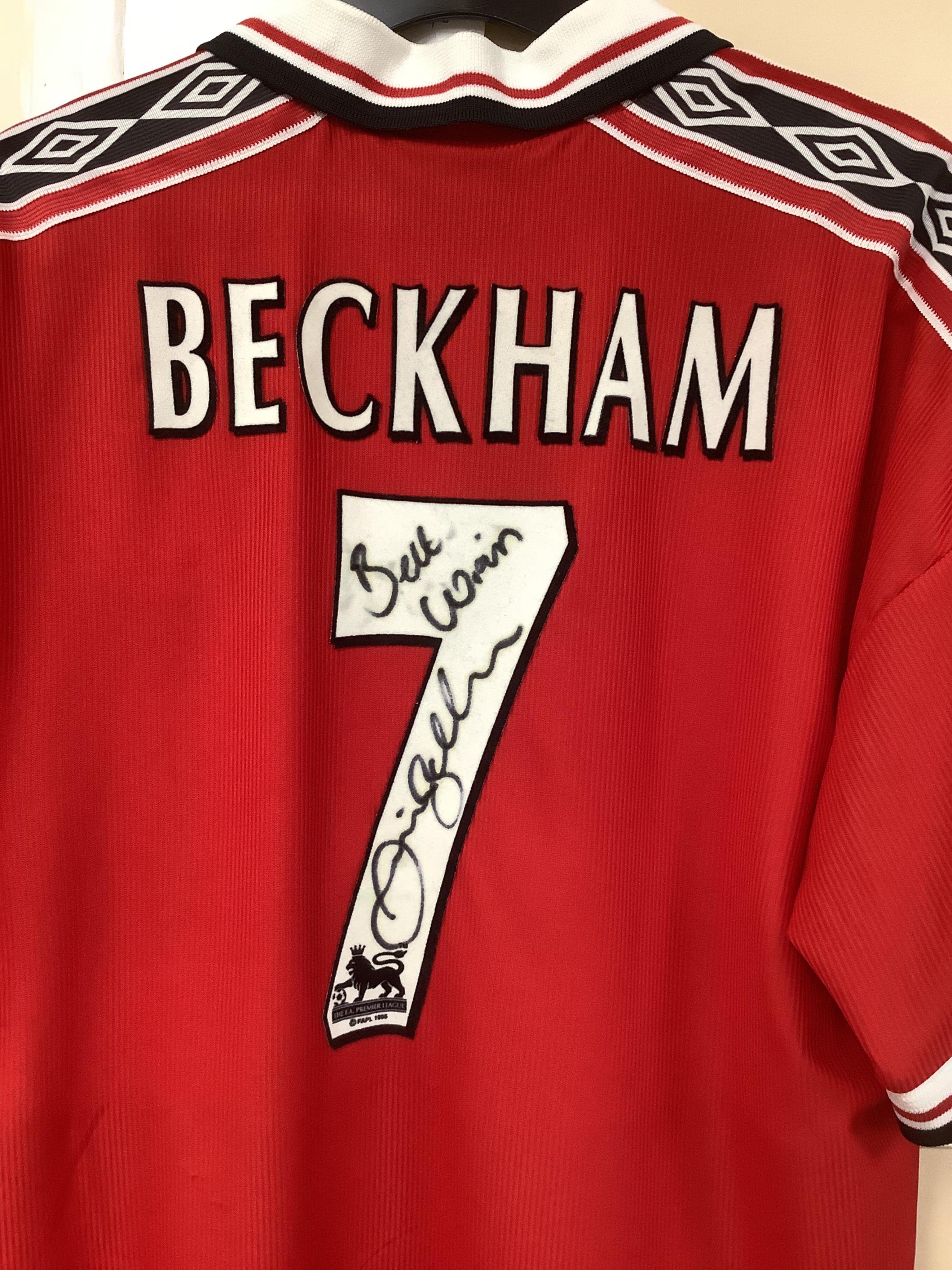 A Manchester United Umbro Sharp polo shirt, signed by David Beckham